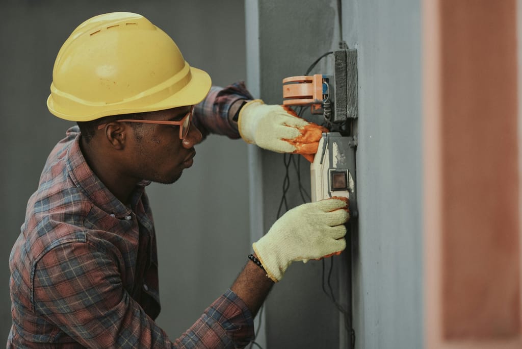 Electrician carrying out electrical installation work in a property