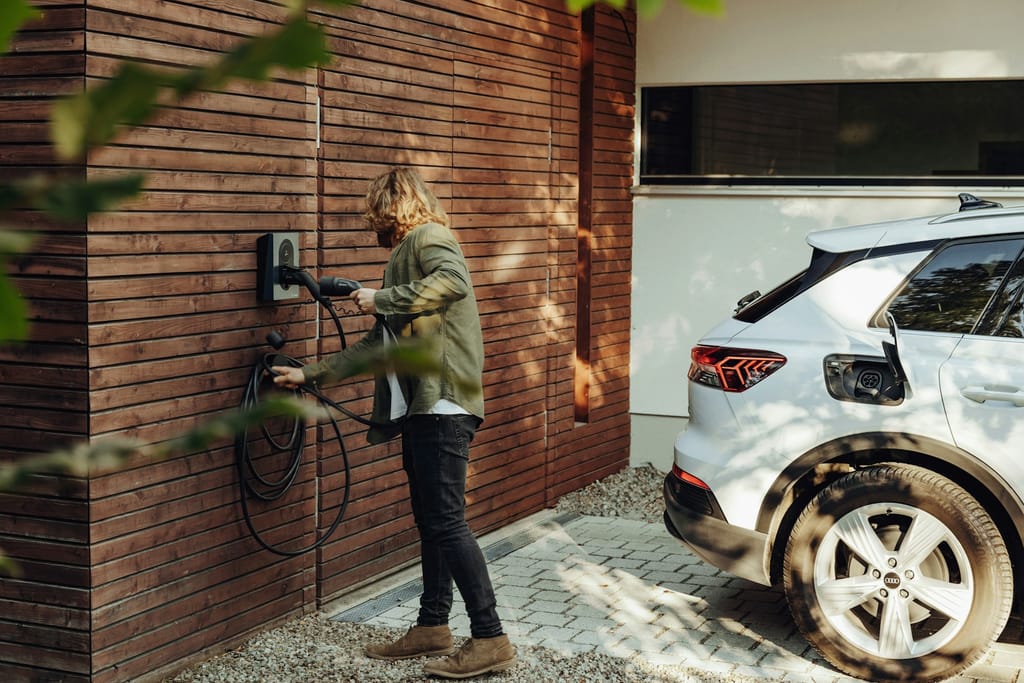 Residential EV charging station mounted near a parking area